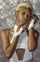 Studded white leather fingerless gloves from Love Khaos festival clothing and streetwear brand.