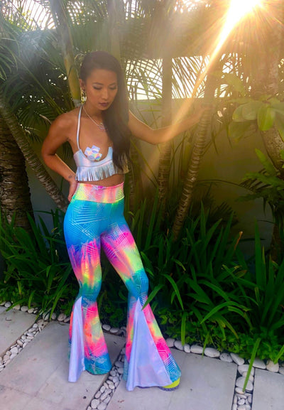 Woman wearing Gender Neutral Style Holographic festival flare pants from Love Khaos Festival Clothing Brand.