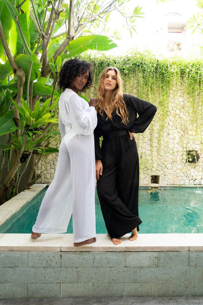 Two women in flowy one piece chiffon Resort Wear Jumpsuits from Love Khaos ethical clothing brand.