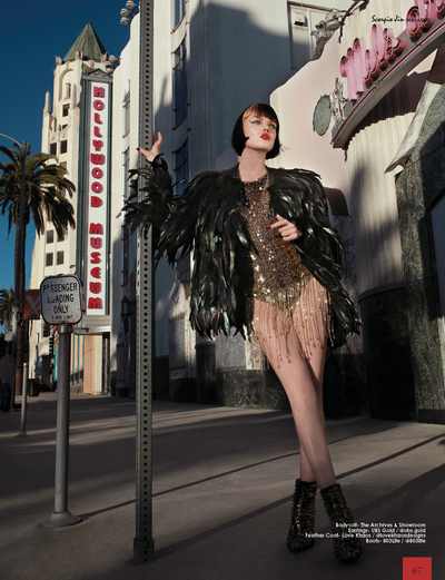 woman wearing black feather jacket and gold sequin dress from Love Khaos avant garde fashion brand.