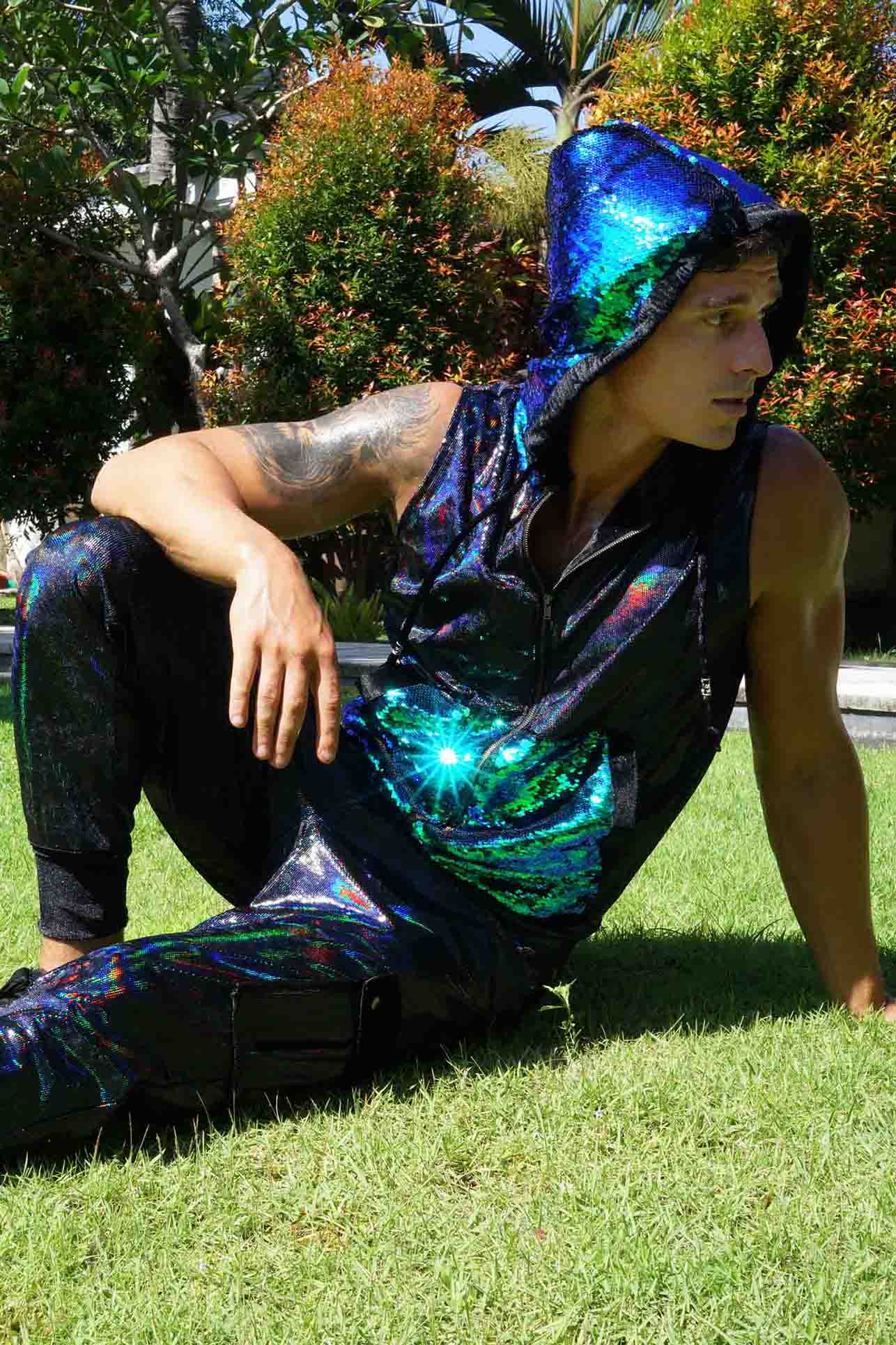 man wearing a sleeveless hoodie holographic vest from Love Khaos.