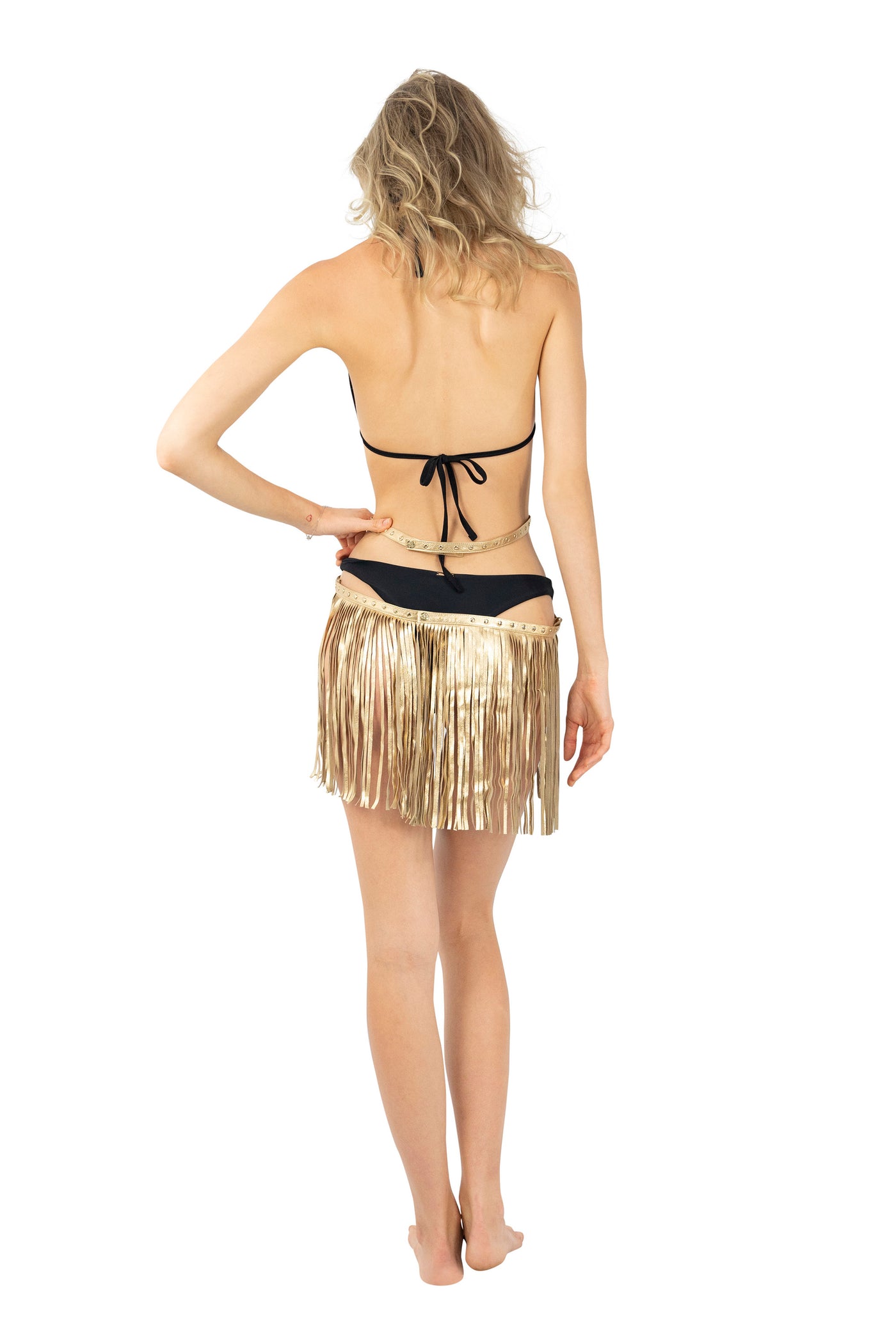 Woman wearing a gold Leather Body Harness with tassel belt skirt from Love Khaos.