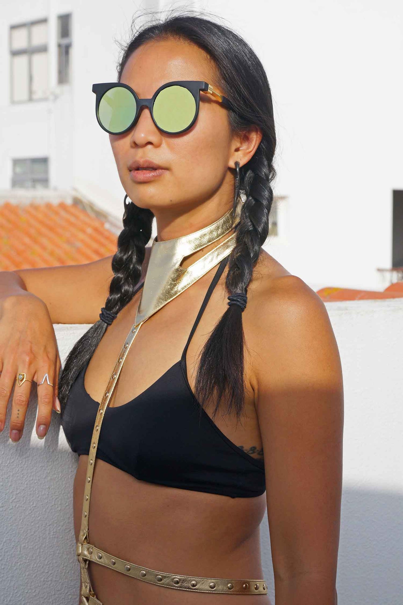 Woman wearing a gold Leather Body Harness from Love Khaos.